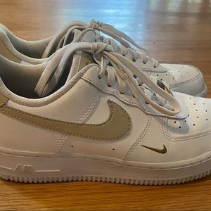 Nike Air Force 1’s, tan swoosh with gold lace tags, size 8